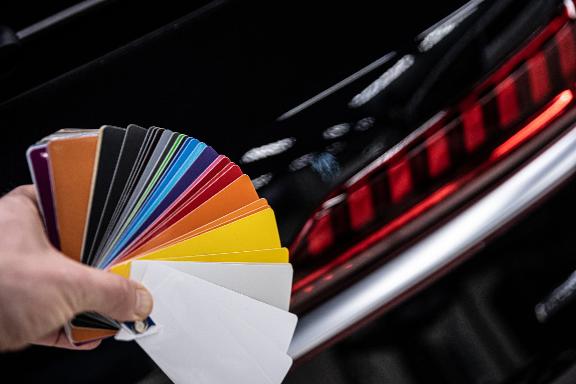 Man choosing color of his car with color sampler.